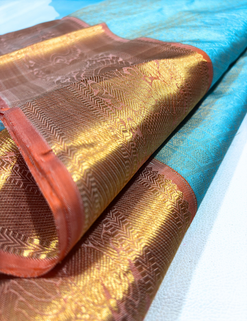 Graceful Sky Blue Kanchipuram Silk Saree with Pastel Orange Border & Gold Zari